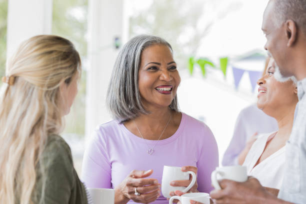 istock Friends drink coffee at charity event 950886916