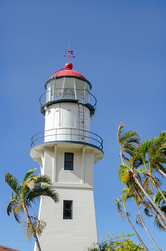 Diamond Head Lighthouse, Oahu, Hawaii, USA, against blue sky.