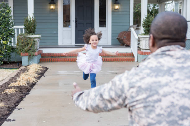 excited girl runs to greet military dad - homecoming imagens e fotografias de stock
