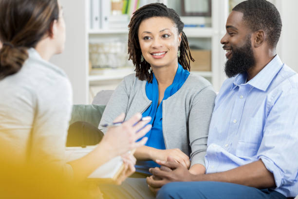 istock Mid adult couple talk with counselor 950887300