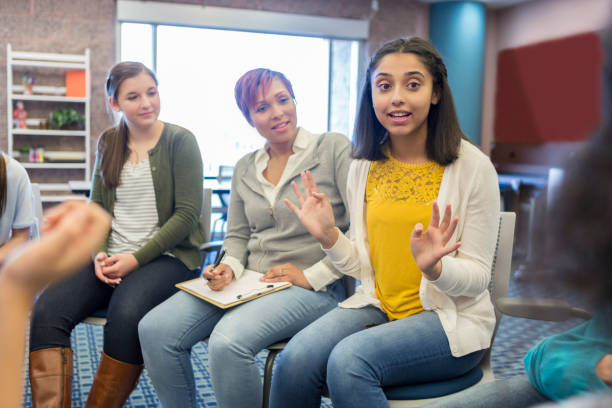 istock School counselor facilitates a group discussion 950887394