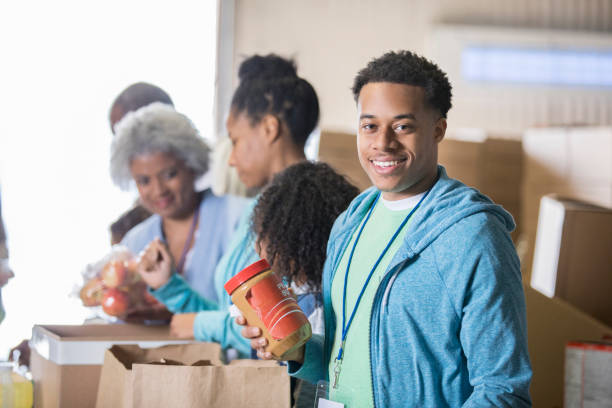 istock Confident man volunteering in food bank 950887548