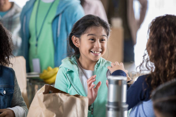 istock Elementary age friends volunteering in food bank 950887570
