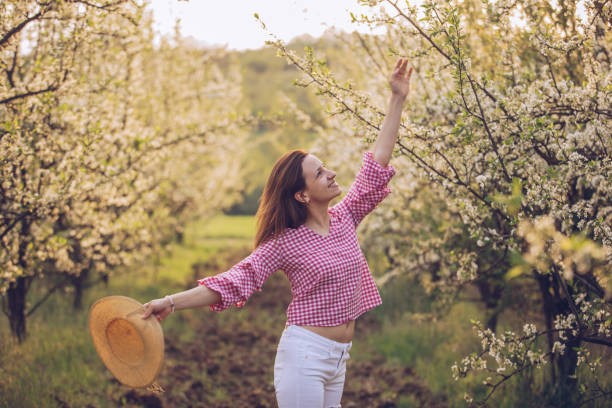 istock Beautiful woman in the orchard 950890918