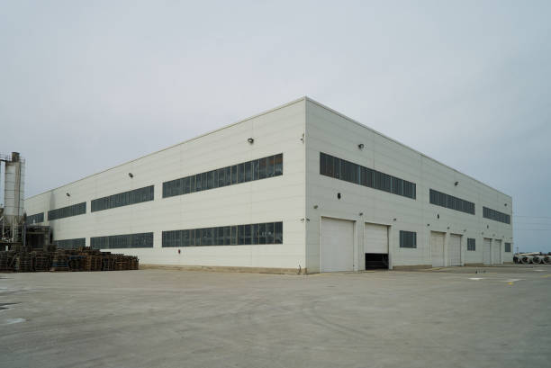 Factory building exterior with warehouse Factory building exterior with warehouse. Industrial production of cement products. Industry manufacturing concept new big tube stock pictures, royalty-free photos & images