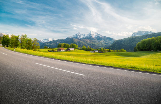 istock Empty asphalt country road with alpine mountain scenery in summer 950891056