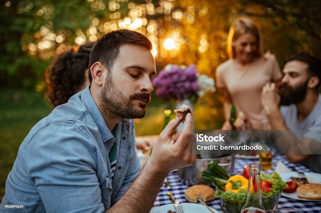 It's so nice and tender Young man enjoying a piece of food Eating Stock Photo