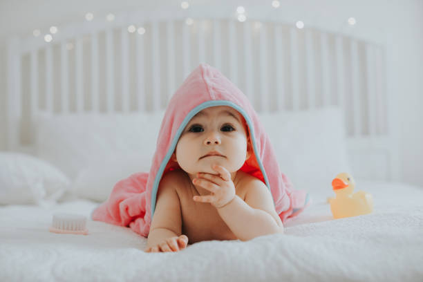 istock Baby girl in pink bathrobe 950899692