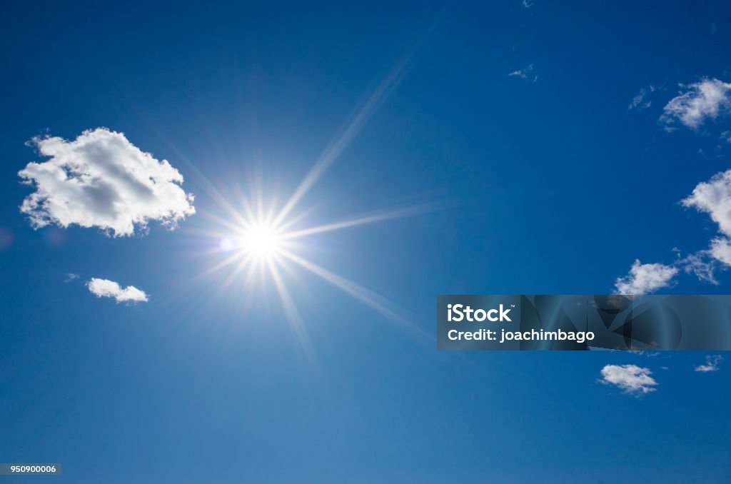 Beautiful blue sky and shining sun, Beautiful blue sky and shining sun, White nice clouds on sunny spring day. Joyful and happy background image. Good weather. Sun Stock Photo