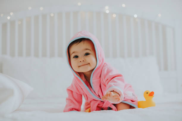 istock Baby girl in pink bathrobe 950900074
