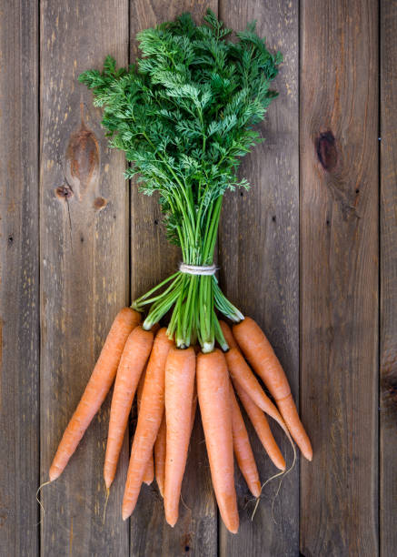 istock carrots on wooden table 950900112