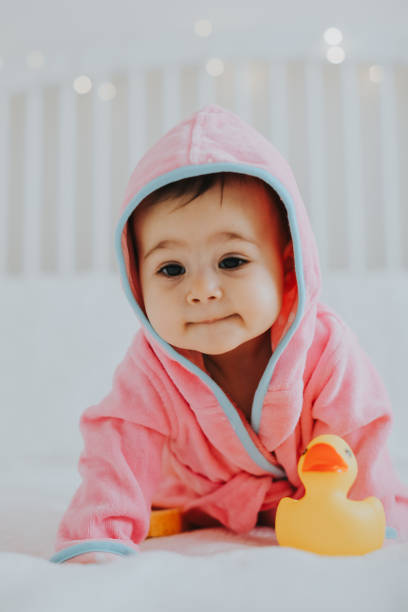 istock Baby girl in pink bathrobe 950900272