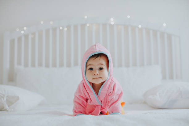 istock Baby girl in pink bathrobe 950900304