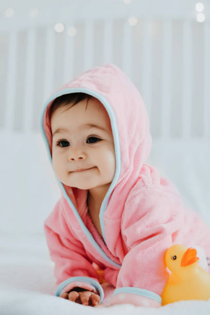 istock Baby girl in pink bathrobe 950900632