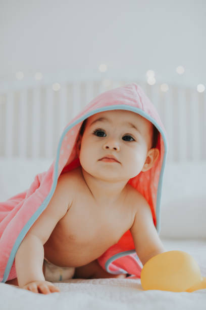istock Baby girl in pink bathrobe 950900786