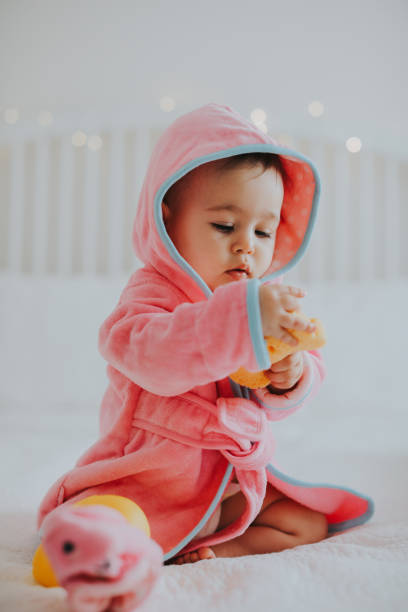 istock Baby girl in pink bathrobe 950900896