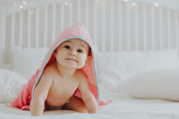 istock Baby girl in pink bathrobe 950901074
