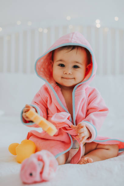 istock Baby girl in pink bathrobe 950901294