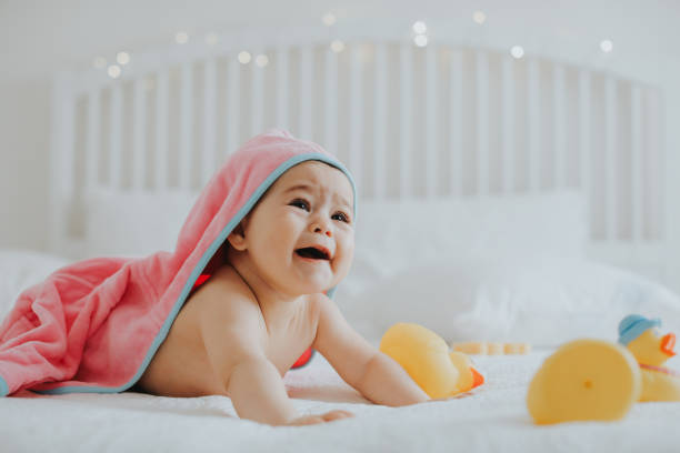 istock Baby girl in pink bathrobe 950901404