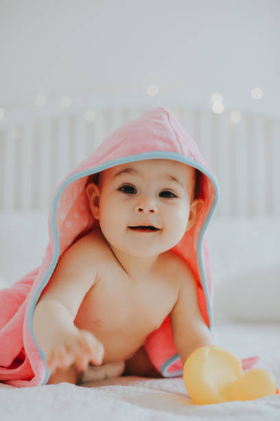 istock Baby girl in pink bathrobe 950904112
