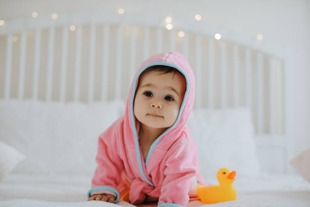 istock Baby girl in pink bathrobe 950904138