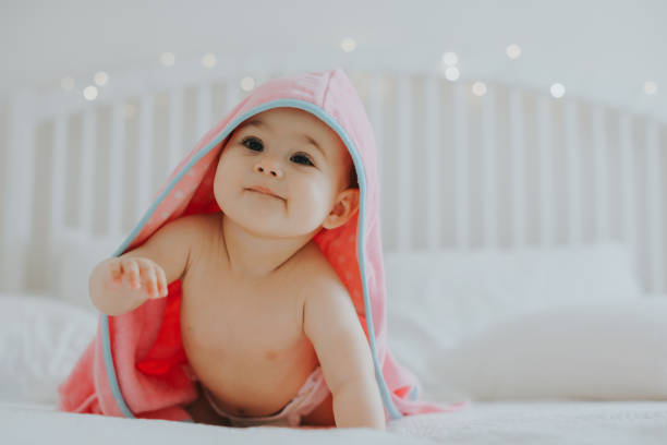 istock Baby girl in pink bathrobe 950904250