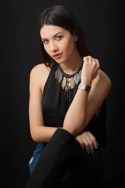 istock Young Lady Sitting Portrait While  Looking to the Camera with Hands on Hips 950907866