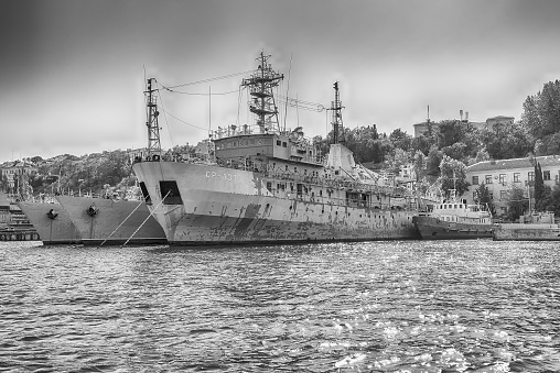 SEVASTOPOL, CRIMEA - AUGUST 24, 2016: Soviet and Russian Black Sea Fleet warships, standing in the quay of the Sevastopol bay, Crimea