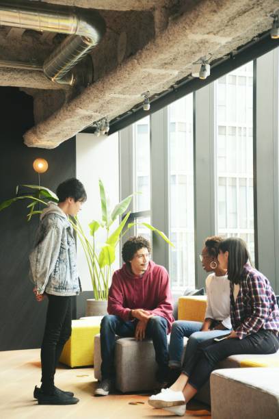 Various ethnic young people meeting in a modern share office