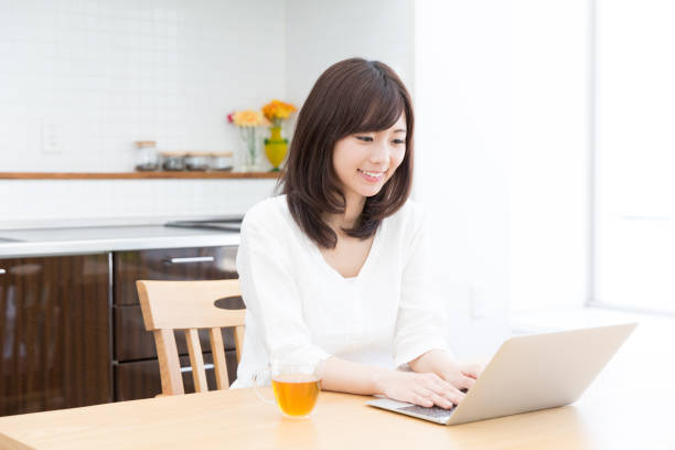 istock attractive asian woman using laptop 950918386