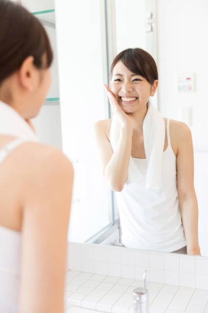 istock attractive asian woman in front of mirror 950918582
