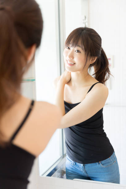 istock attractive asian woman in front of mirror 950918624