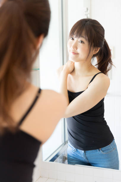 istock attractive asian woman in front of mirror 950918630