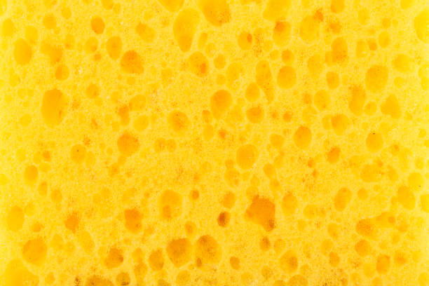 istock texture yellow foam rubber, synthetic sponge with large pores, close-up background 950918894