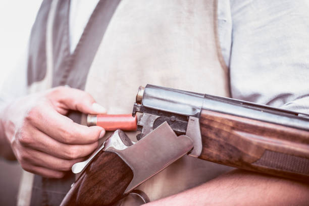 istock Close up of Hunter Putting Bullets in his Gun 950919066