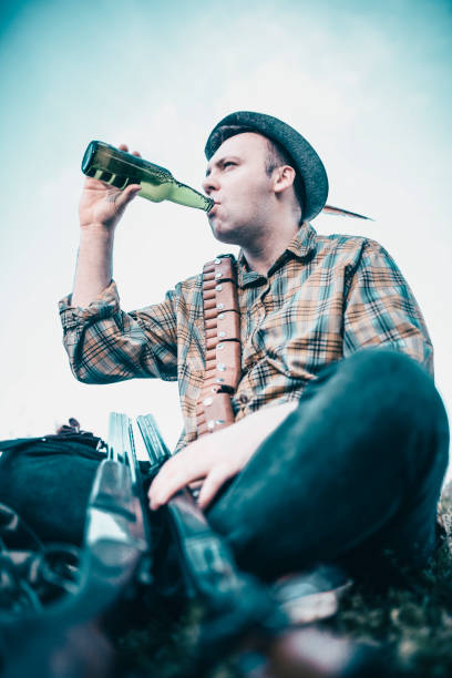 istock Hunter with Hat Drink Beer on his Hunting Brake 950919734