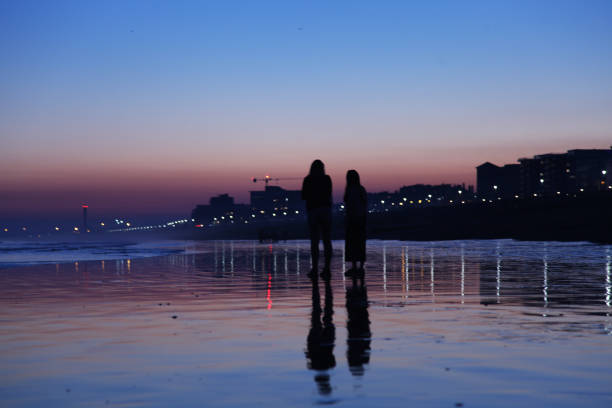 People enjoying the Sunset, in Brighton.  Colourful is the most beautiful sunset in the world