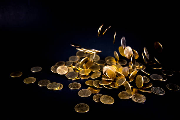 istock Falling gold coins money in dark background, business concept. 950928100