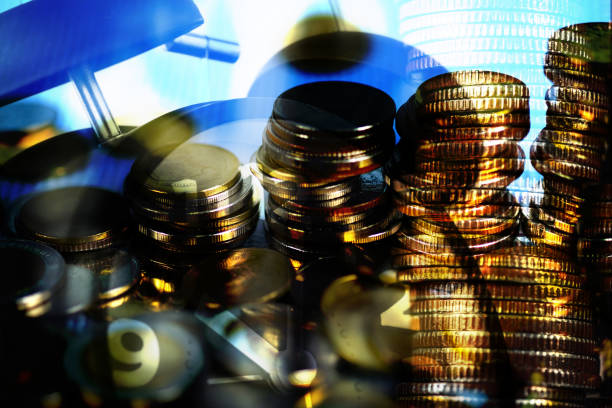 istock Double exposure of coin stack and alarm clock with city background and financial graph, business finance concept. 950928144