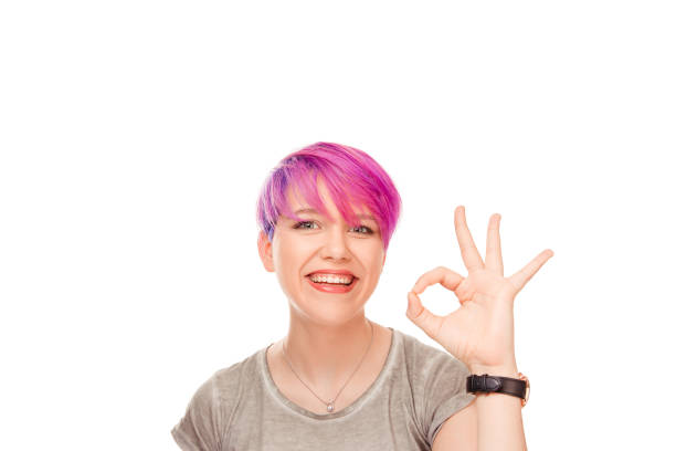 istock woman shows ok sign as expresses approval, gestures in studio 950931832