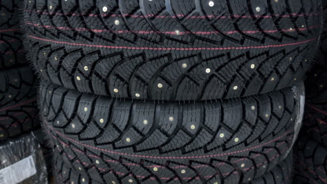 Car winter tires with spikes. Studded tires close up.