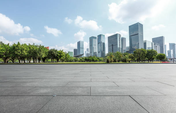 istock empty square floor and modern commercial buildings 950937612