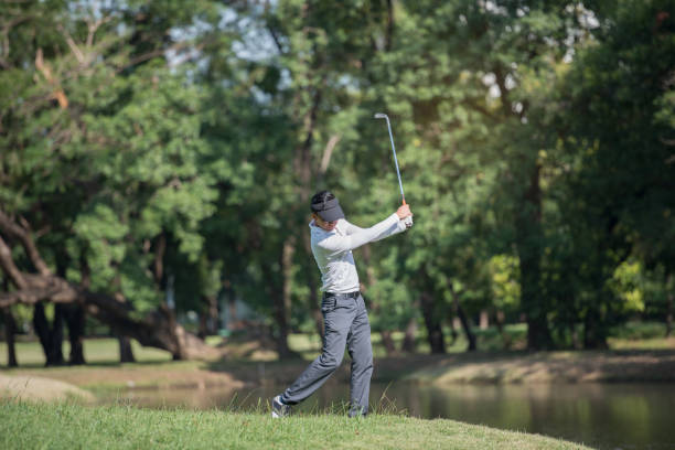 istock Golfers asia man show hit sweeping at green lawn 950938954