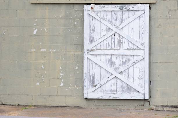 istock Sliding barn door on old brick building 950939516