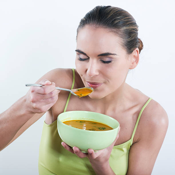 istock woman eating soup is good for you 95093995