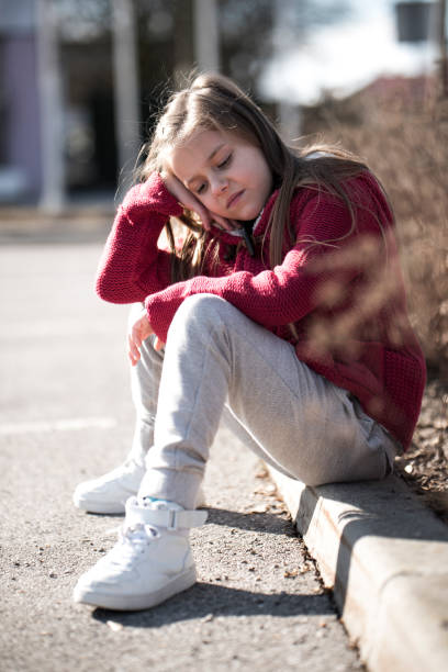 istock Girl sitting outdoors 950943290