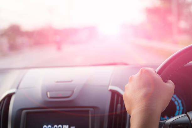istock Soft focus driver hand holding steering wheel while driving on the road. 950953092