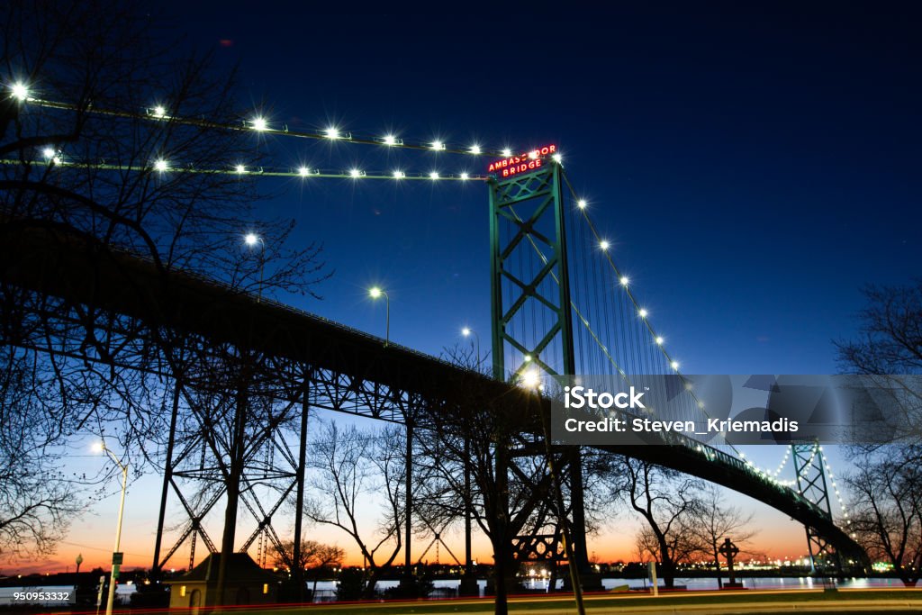 Ambassador Bridge The Ambassador Bridge links Detroit, Michigan, USA with Windsor, Ontario, Canada.   It is one of the most important trade routes in North America. Detroit - Michigan Stock Photo