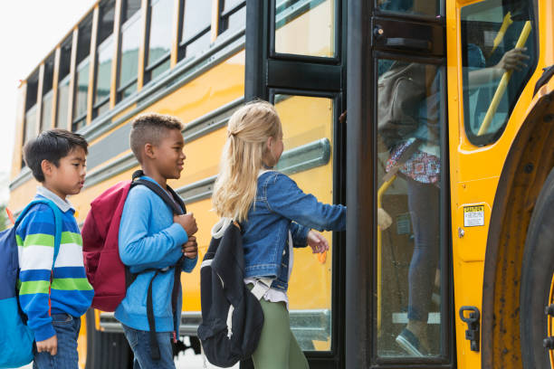 istock Multi-ethnic children boarding a school bus 950956002