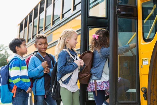 istock Multi-ethnic children boarding a school bus 950956004